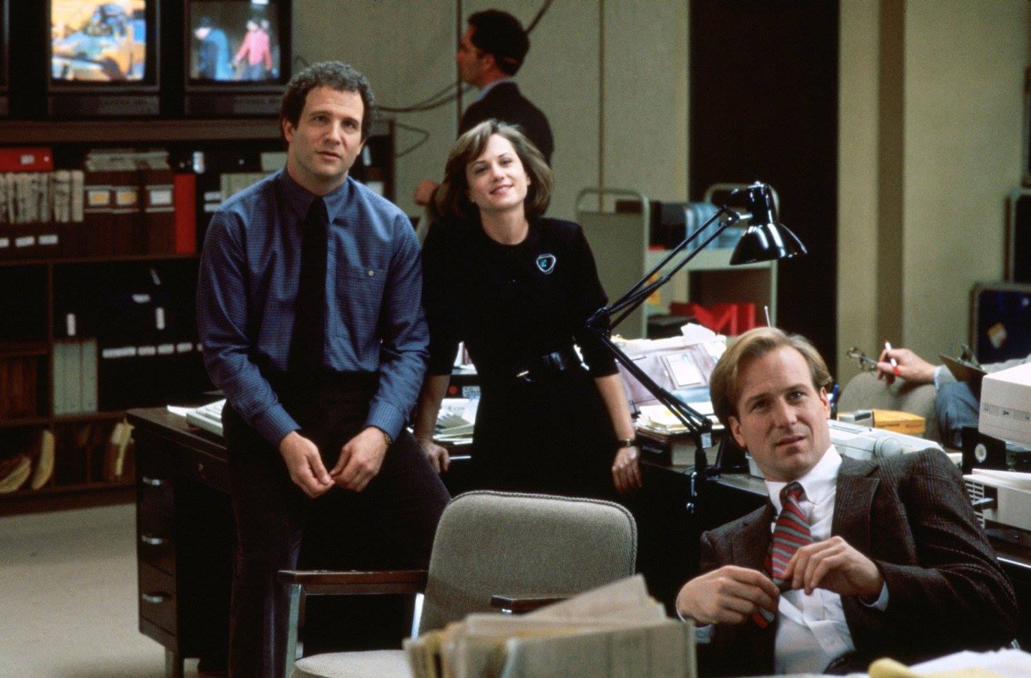 Albert Brooks, Holly Hunter, and William Hurt in the back office of the newsroom