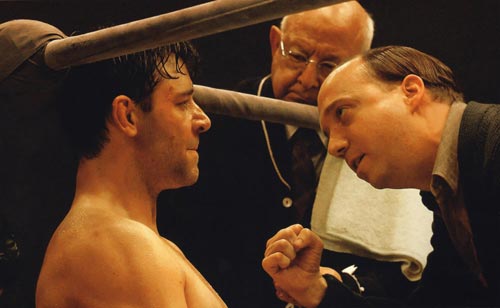 Russell Crowe, as heavyweight boxing champion James J. Braddock, receiving advice from Paul Giamatti