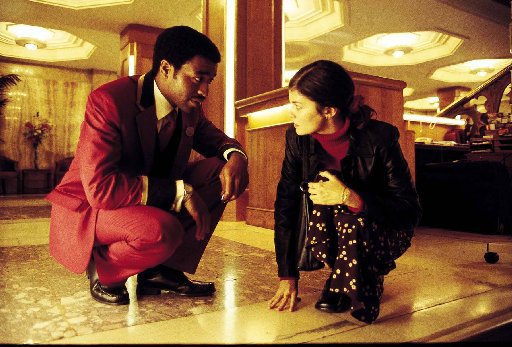 Chiwetel Ejiofor and Audrey Tautou discreetly converse in the lobby of a London hotel.