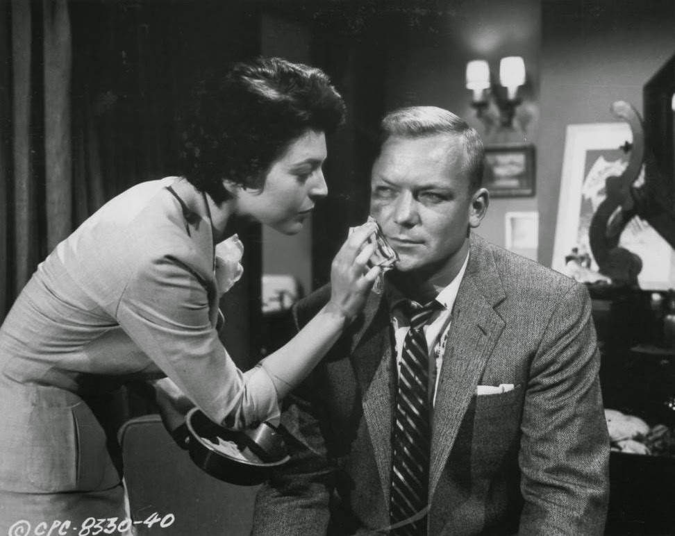 Marie Gardner (Anne Bancroft) tends to James Vanning (Aldo Ray) after a beating.